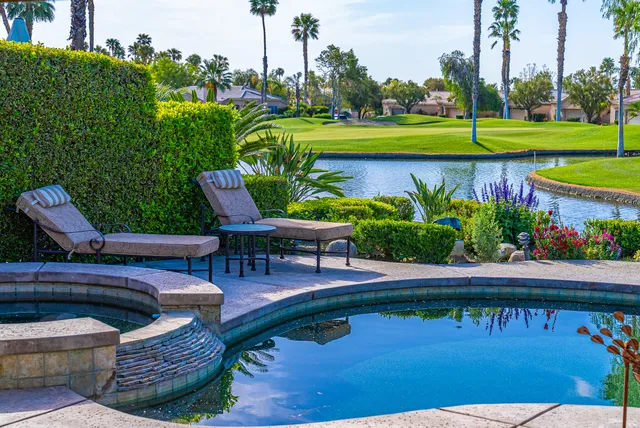 a view of swimming pool with outdoor seating and yard