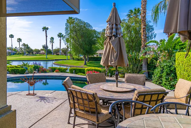 a dining area with furniture and a garden