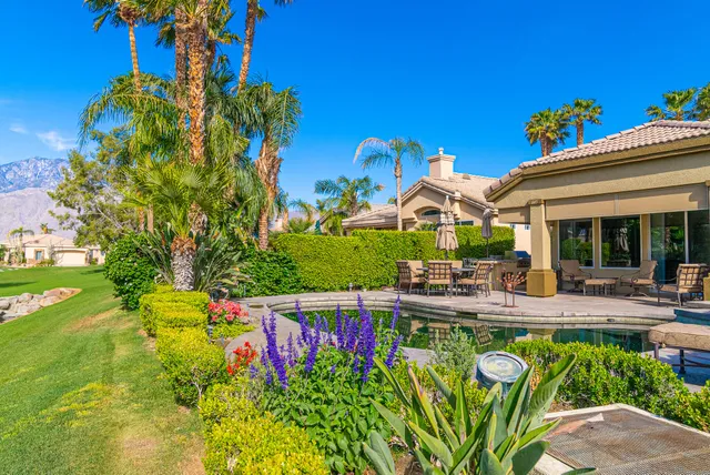 a view of a swimming pool with a table and chairs