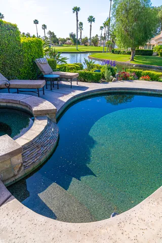 a view of a swimming pool and outdoor seating