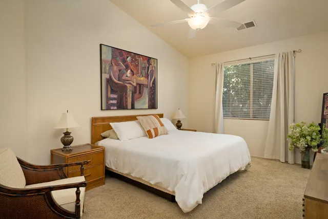 a bedroom with a bed and window