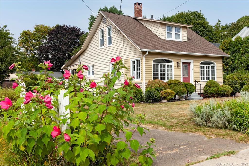 97 Grove Street Clinton, CT 06413 - Photo 1 of 1 a front view of house with yard and flowers around