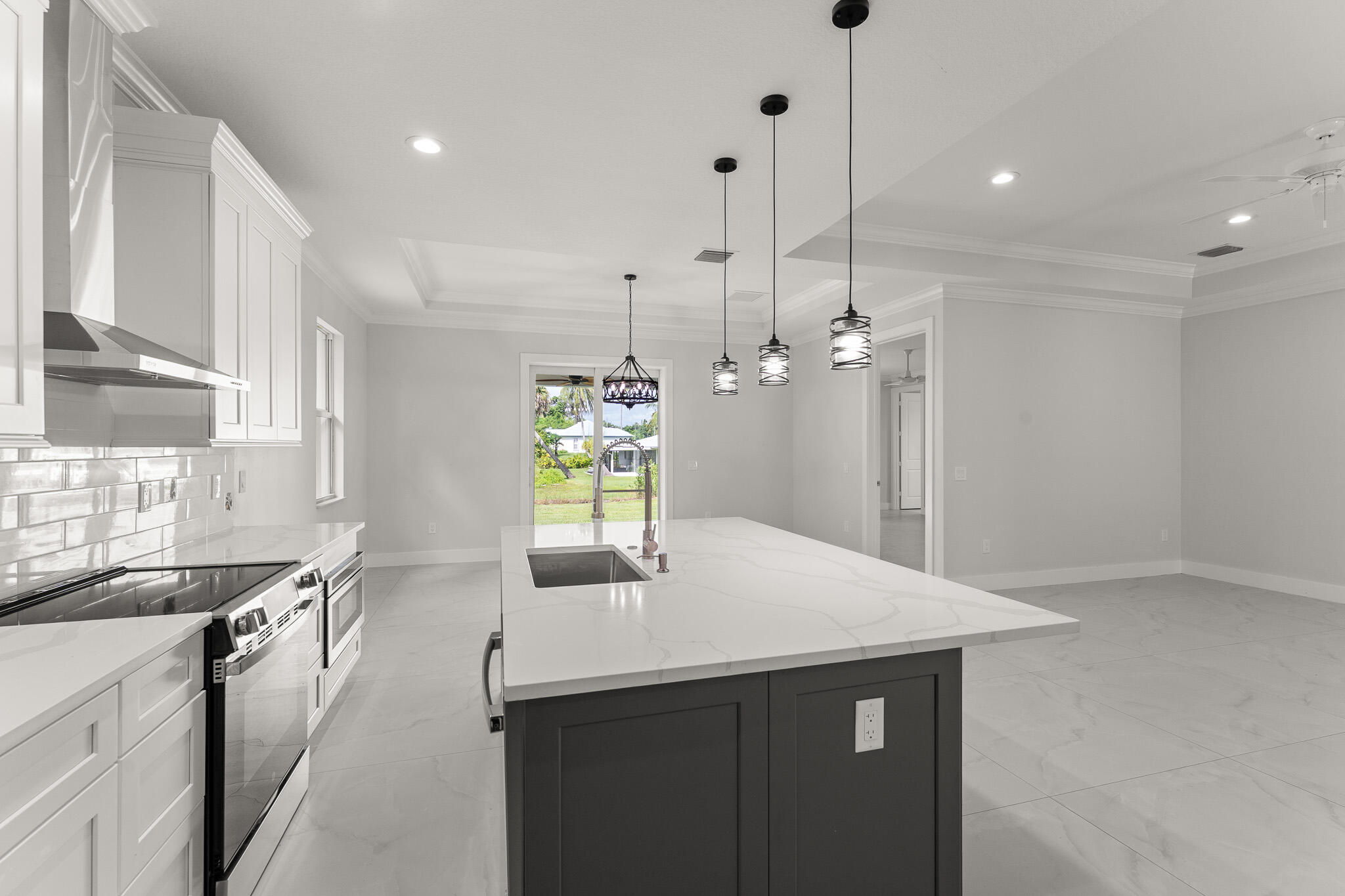 5470 Southeast Front Avenue Stuart, FL 34997 - Photo 17 of 37 a kitchen with kitchen island a sink appliances and a counter top space