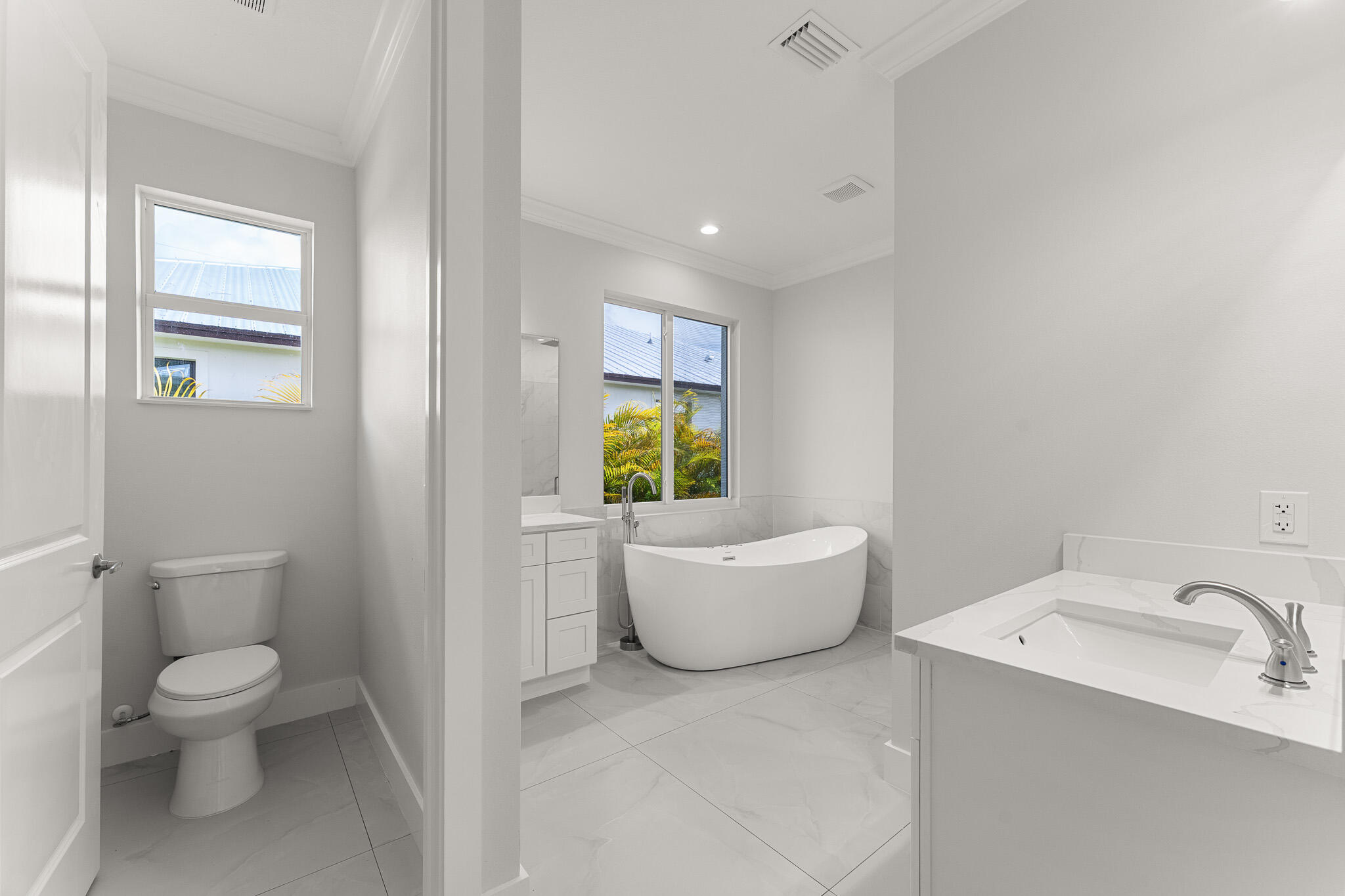 5470 Southeast Front Avenue Stuart, FL 34997 - Photo 26 of 37 a white toilet sitting next to a bathroom sink