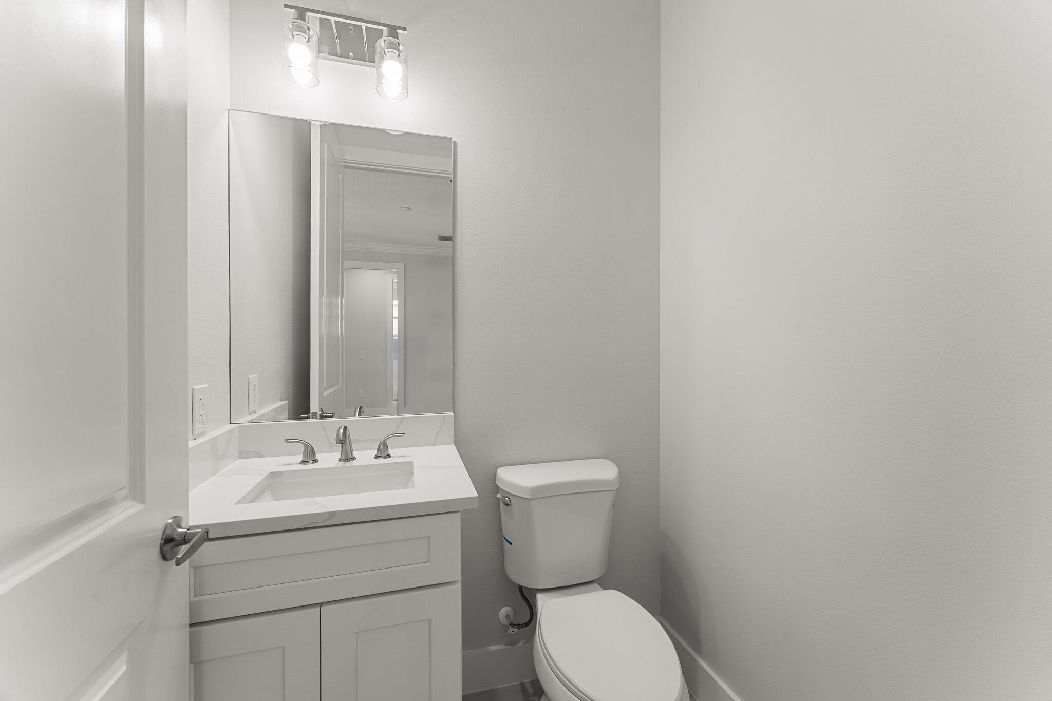 5470 Southeast Front Avenue Stuart, FL 34997 - Photo 27 of 37 a bathroom with a sink mirror and toilet