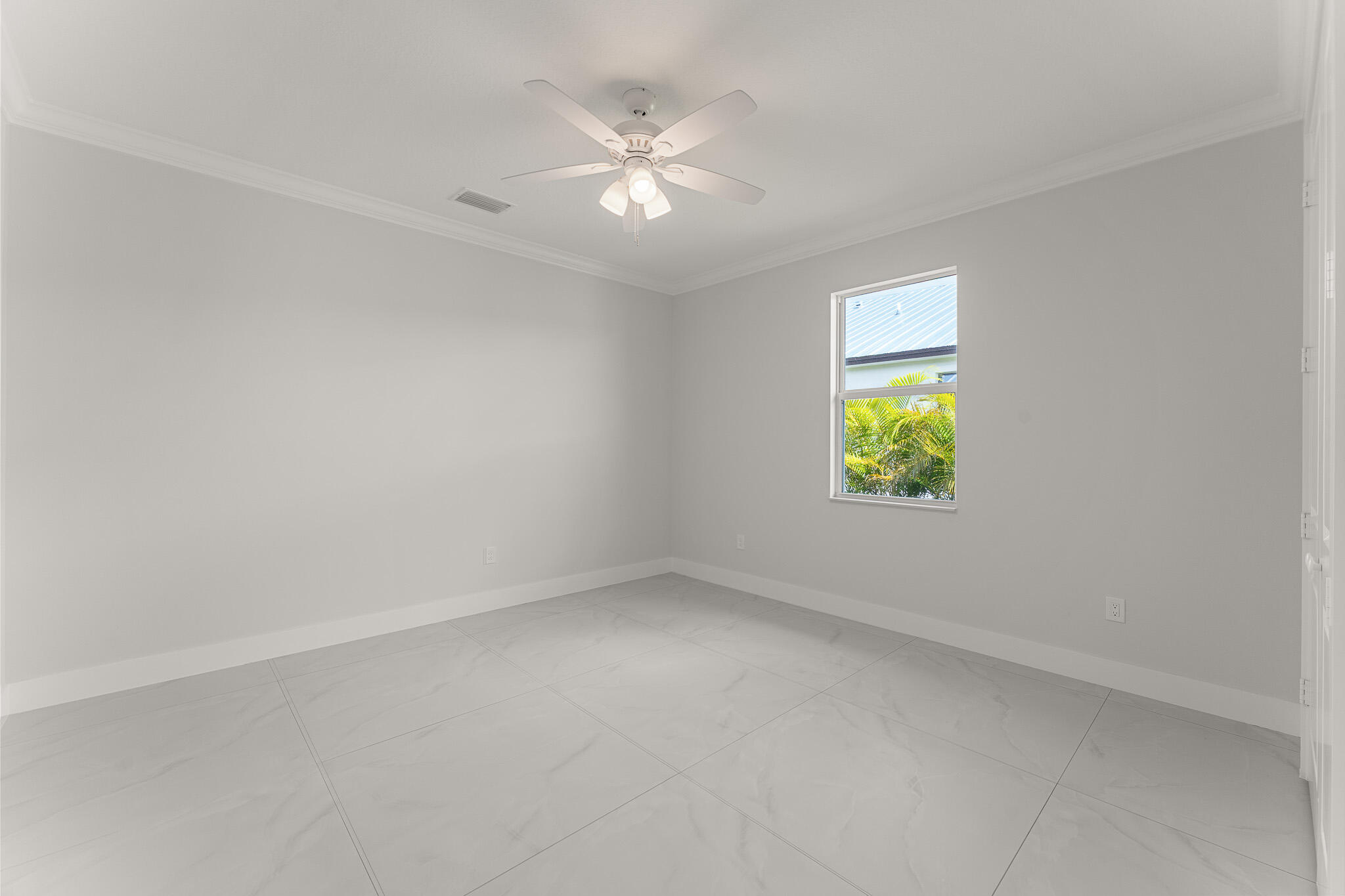 5470 Southeast Front Avenue Stuart, FL 34997 - Photo 28 of 37 an empty room with a window and a fan