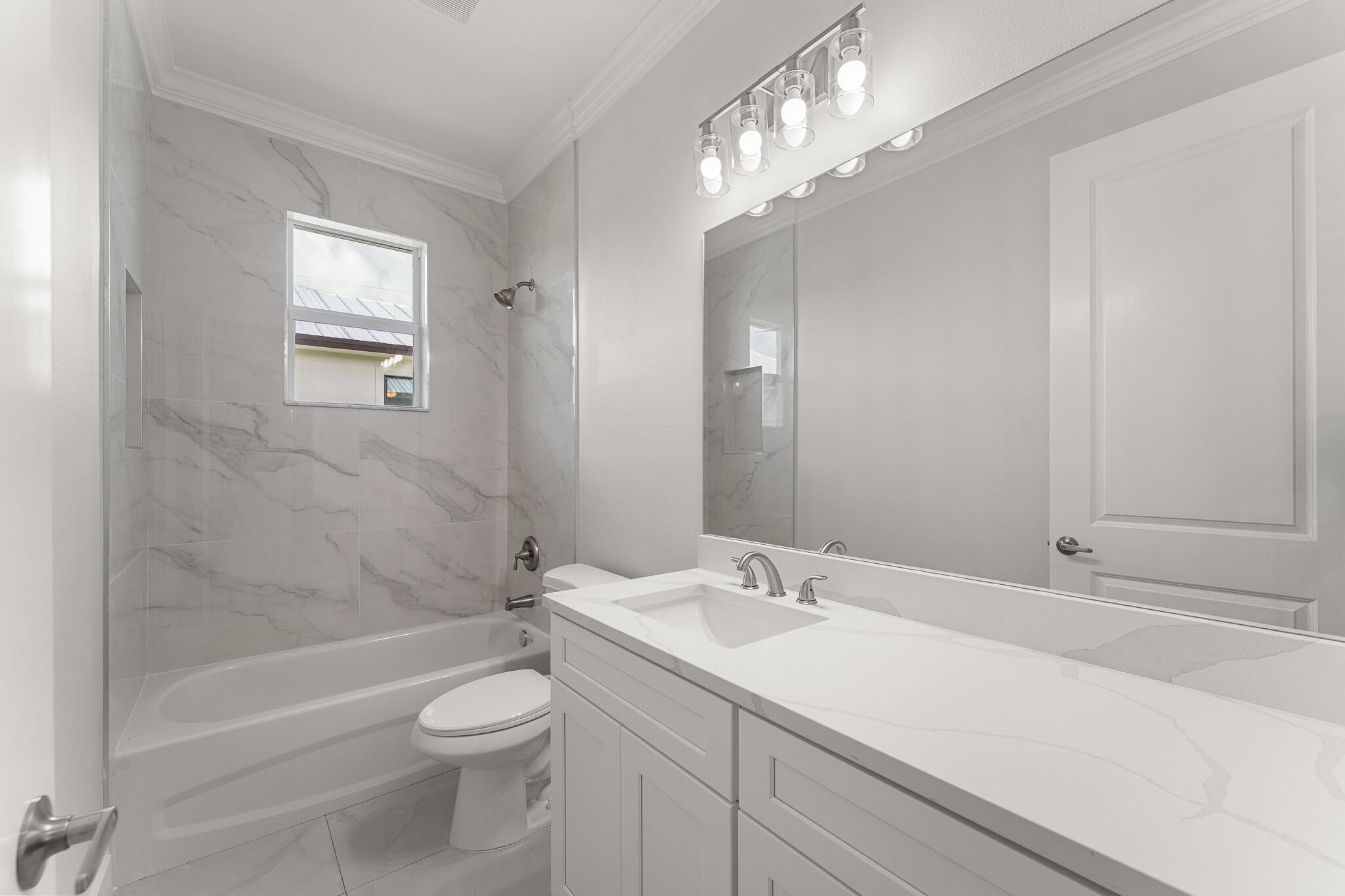 5470 Southeast Front Avenue Stuart, FL 34997 - Photo 29 of 37 a bathroom with a sink a toilet and shower