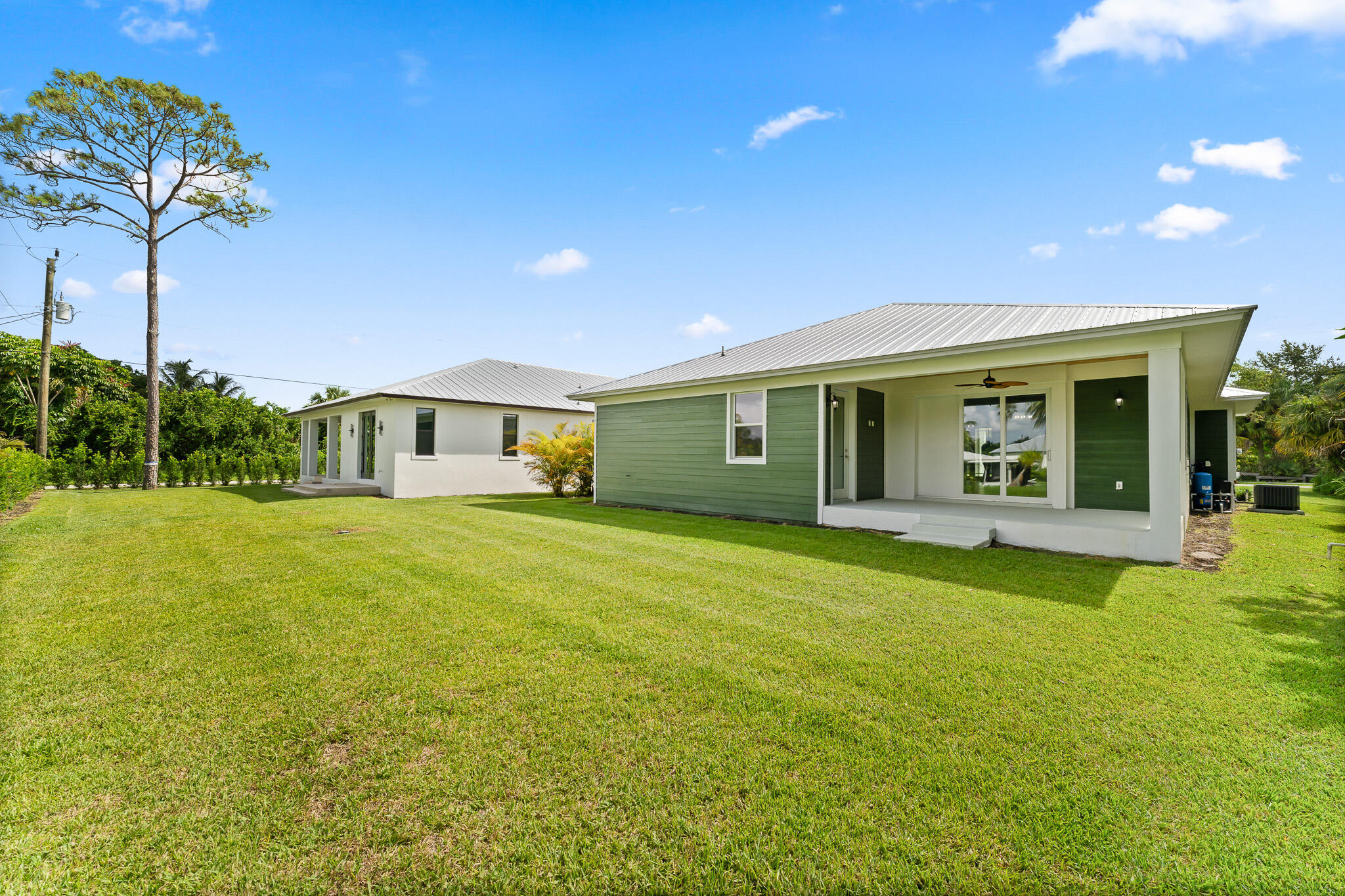 5470 Southeast Front Avenue Stuart, FL 34997 - Photo 36 of 37 a front view of a house with yard and green space