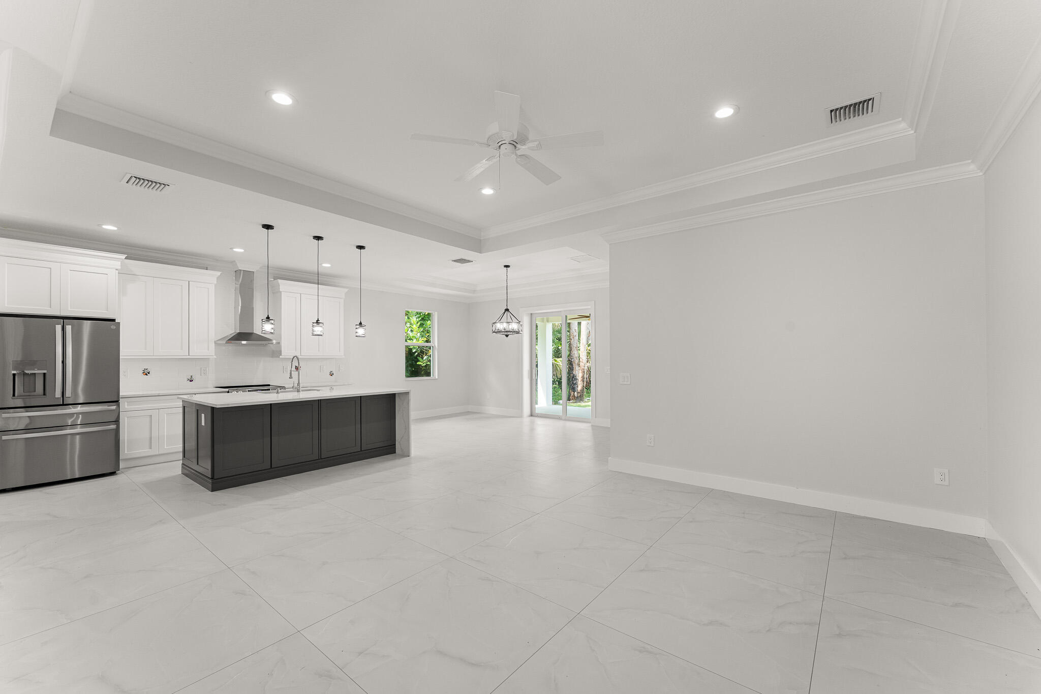 5470 Southeast Front Avenue Stuart, FL 34997 - Photo 6 of 37 a large white kitchen with a refrigerator a sink and a stove top oven