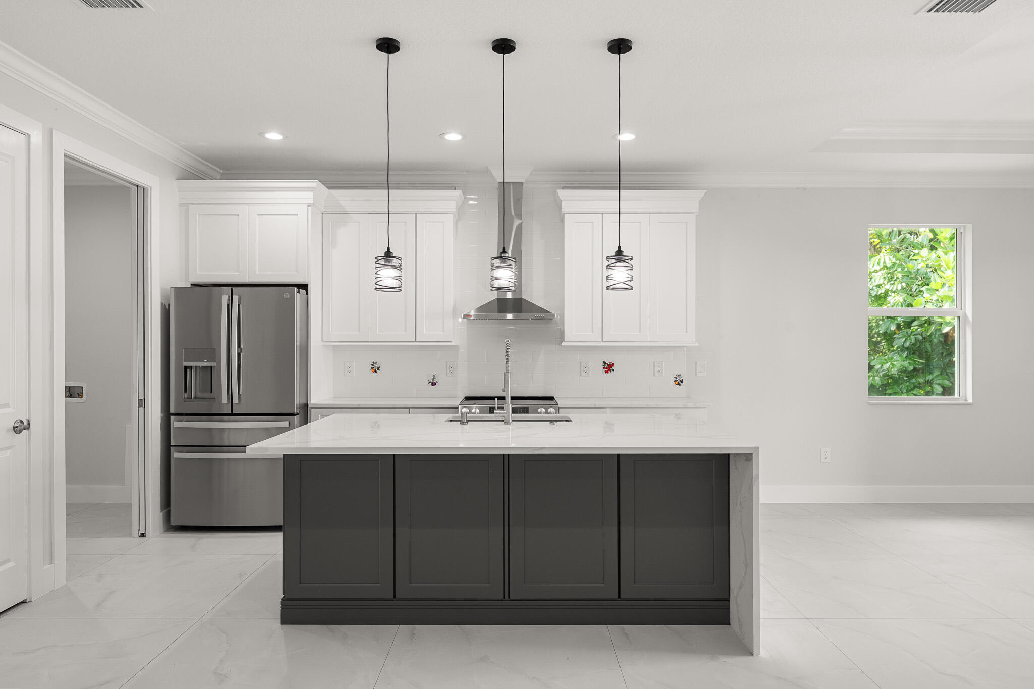 5470 Southeast Front Avenue Stuart, FL 34997 - Photo 8 of 37 a kitchen with kitchen island a sink a counter space appliances and cabinets