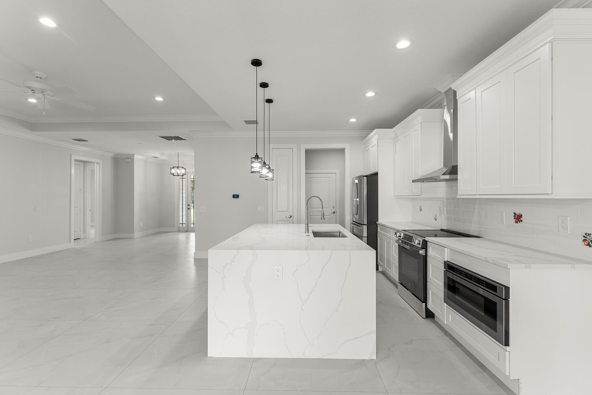 5470 Southeast Front Avenue Stuart, FL 34997 - Photo 10 of 37 a large white kitchen with a stove a sink and a refrigerator