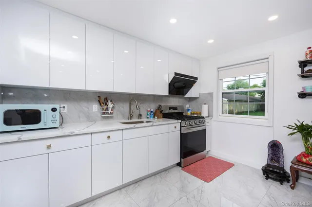 a kitchen with stainless steel appliances kitchen island granite countertop a sink and a stove