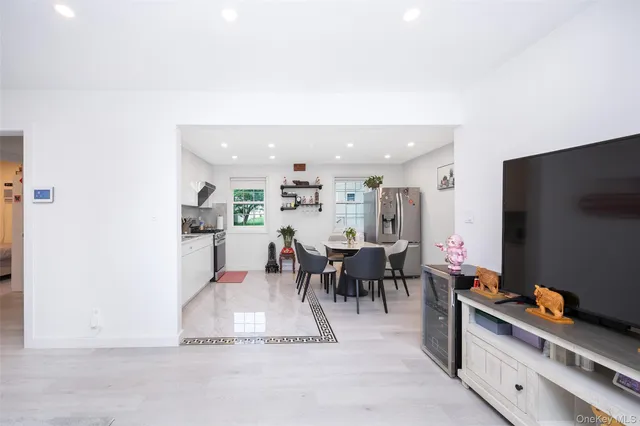 a dining room with furniture and a flat screen tv