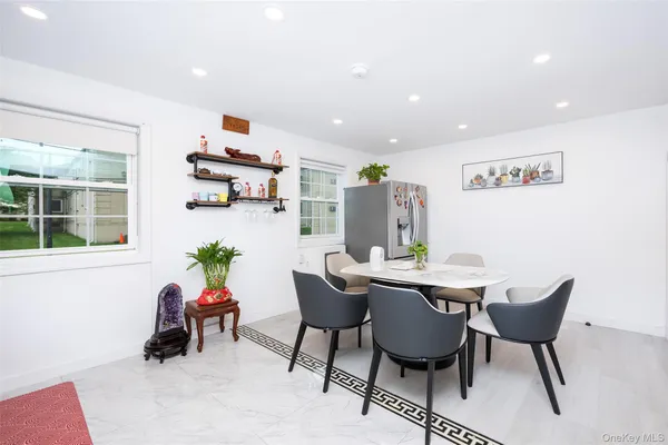 a dining room with furniture and window