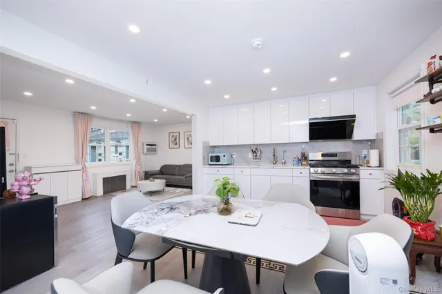 a view of a dining room with furniture and a kitchen