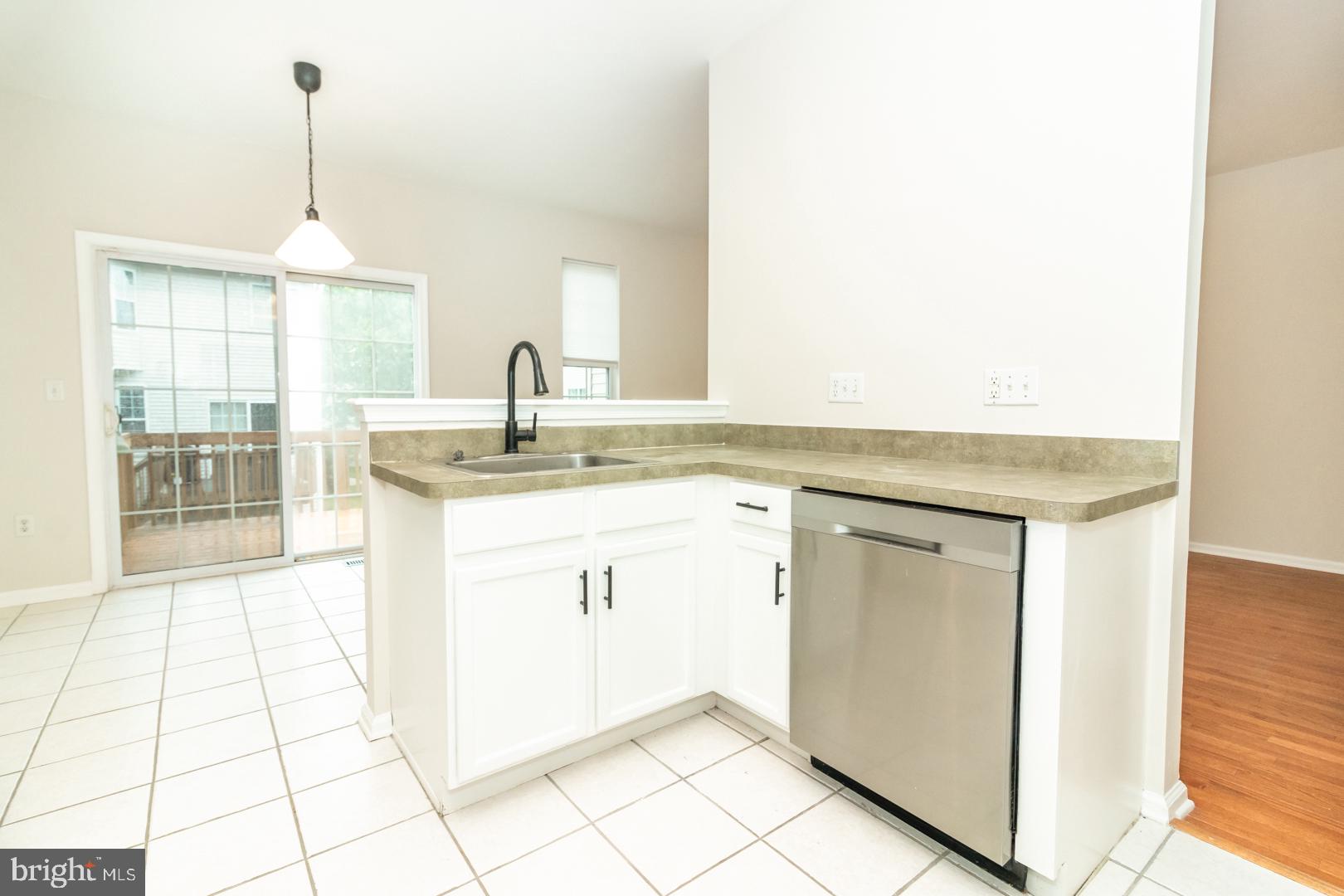 226 Hawthorne Way Riverside, NJ 08075 - Photo 10 of 32 a kitchen with sink cabinets and chandelier