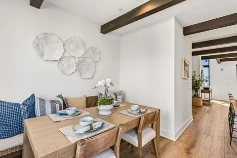 a view of a dining room with furniture wooden floor and chandelier