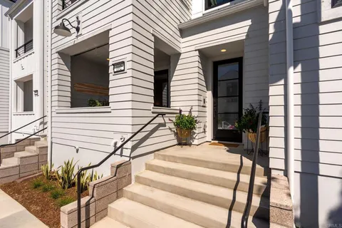 a view of house with stairs and wooden floor