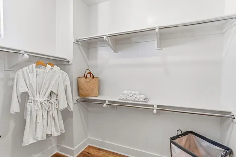 a close view of walk in closet and wooden floor