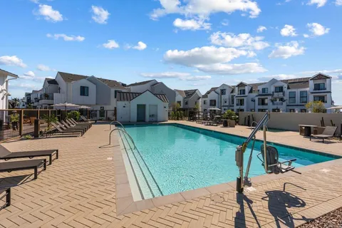 a view of a tennis ground with large trees