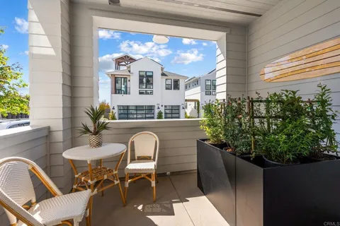 a balcony with table and chairs