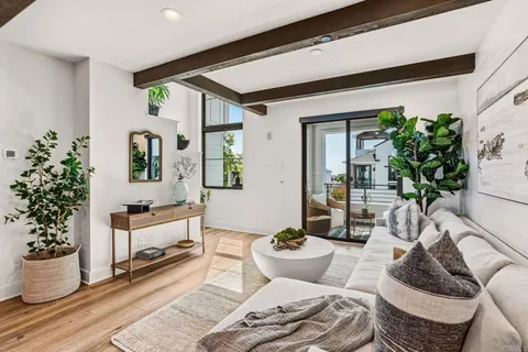 a living room with furniture and flowers
