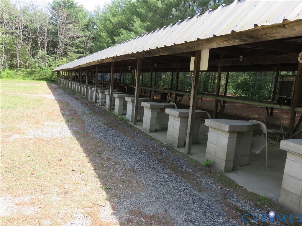 a view of a patio with table and chairs and wooden fence