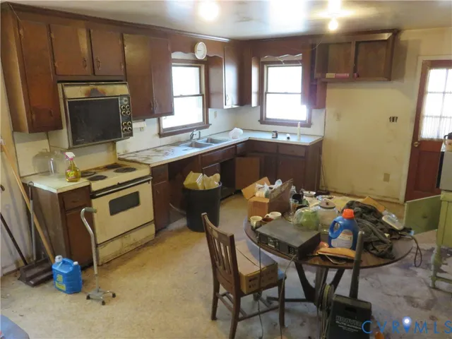 a kitchen with a sink appliances and cabinets