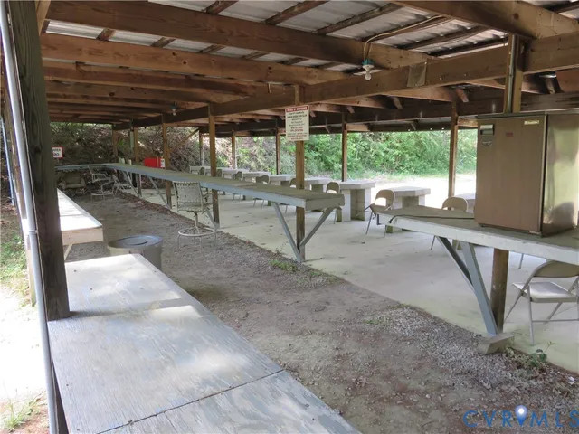 a backyard of a house with trees and outdoor seating