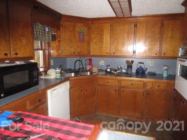 3018 Goldmine Road Monroe, NC 28110 - Photo 18 of 33 a kitchen with stainless steel appliances wooden cabinets and a counter top space