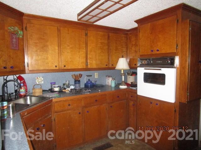 3018 Goldmine Road Monroe, NC 28110 - Photo 20 of 33 a kitchen with a stove and a refrigerator