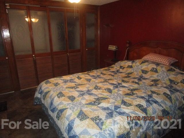 3018 Goldmine Road Monroe, NC 28110 - Photo 25 of 33 a bedroom with a bed and mirror