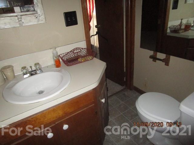 3018 Goldmine Road Monroe, NC 28110 - Photo 32 of 33 a bathroom with a toilet sink and mirror
