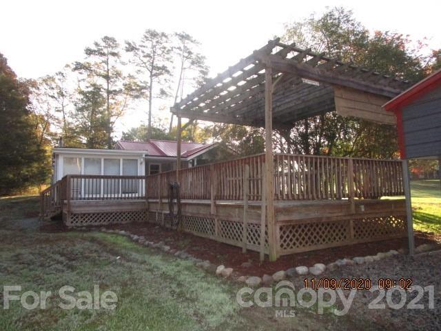 3018 Goldmine Road Monroe, NC 28110 - Photo 6 of 33 a view of a wooden house with a large trees