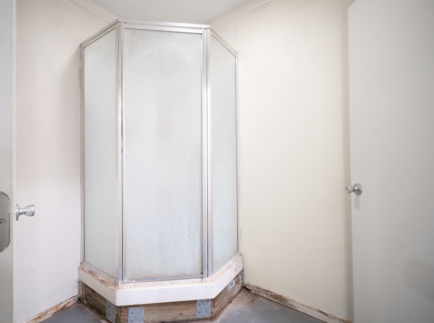 26166 Eddy Way Madera, CA 93638 - Photo 22 of 25 a bathroom with a glass shower door
