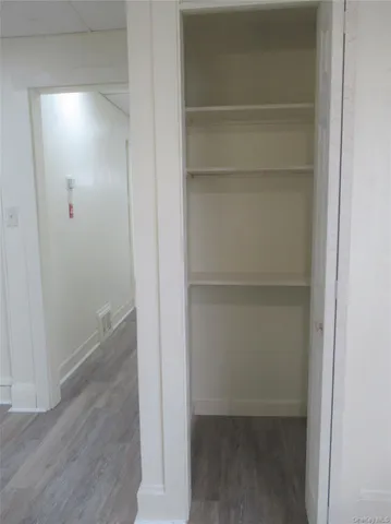 a view of walk in closet with empty racks