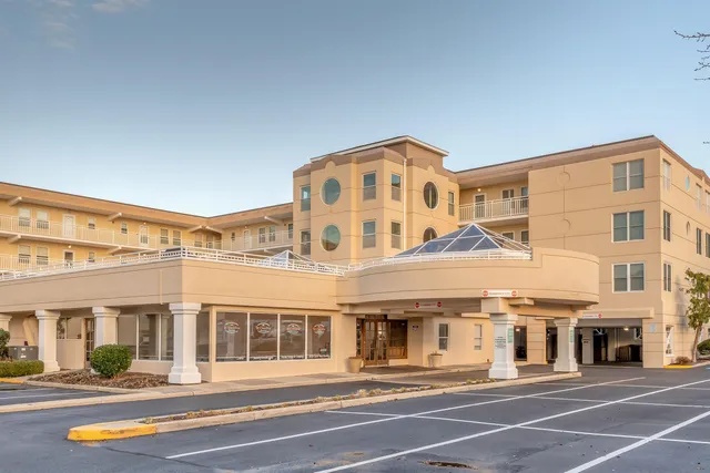 a view of a kitchen with white cabinets and stainless steel appliances