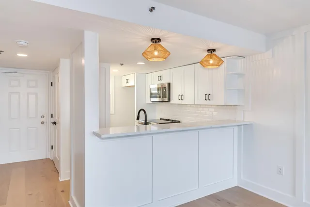 a view of a room with wooden floor and window