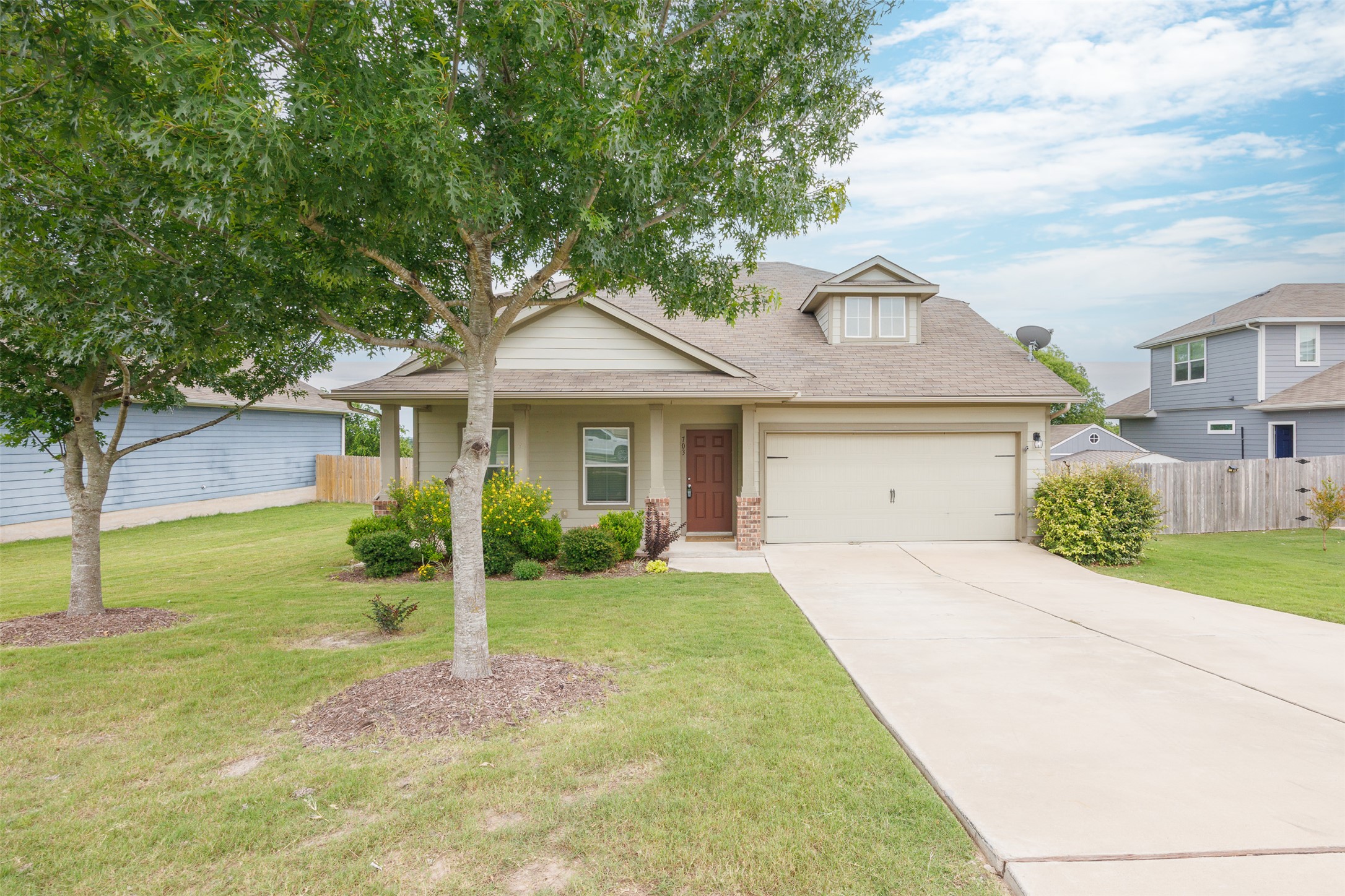 Well-kept landscape surrounds this inviting residence with an integrated garage and a front dormer.