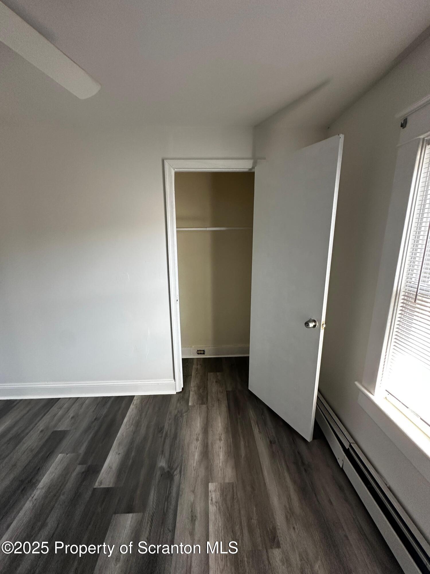 1417 Cornell Street, Unit 2 Scranton, PA 18504 - Photo 10 of 11 an empty room with wooden floor and windows
