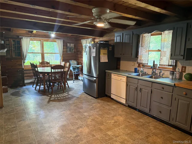 a kitchen with stainless steel appliances a refrigerator sink and cabinets