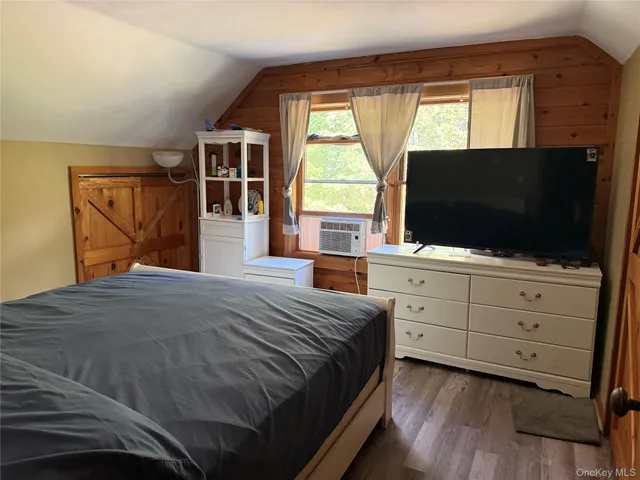a bedroom with furniture and a large window