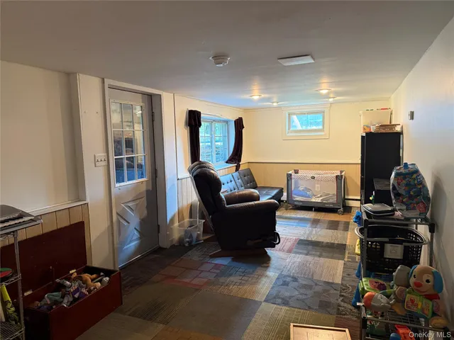 a room with pool table and chairs