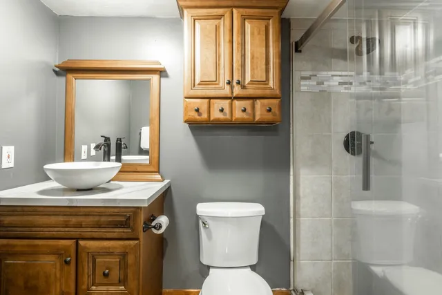 a bathroom with a sink toilet and shower
