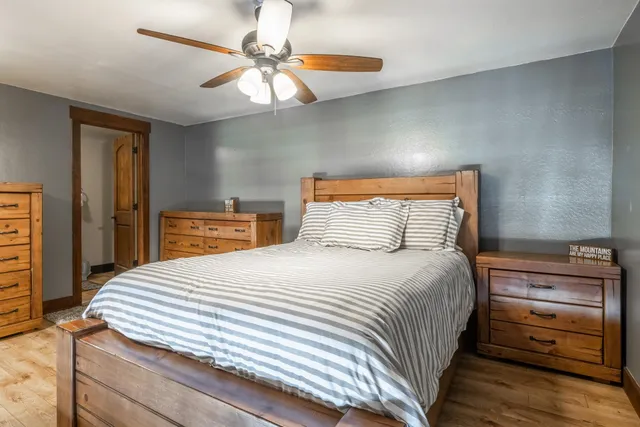 a bedroom with a bed and a chandelier