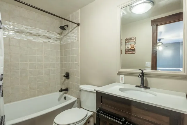 a bathroom with a sink toilet a mirror and shower