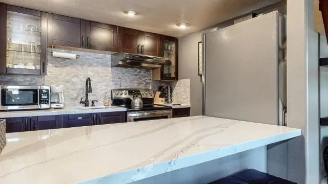 a kitchen with stainless steel appliances a sink stove and refrigerator