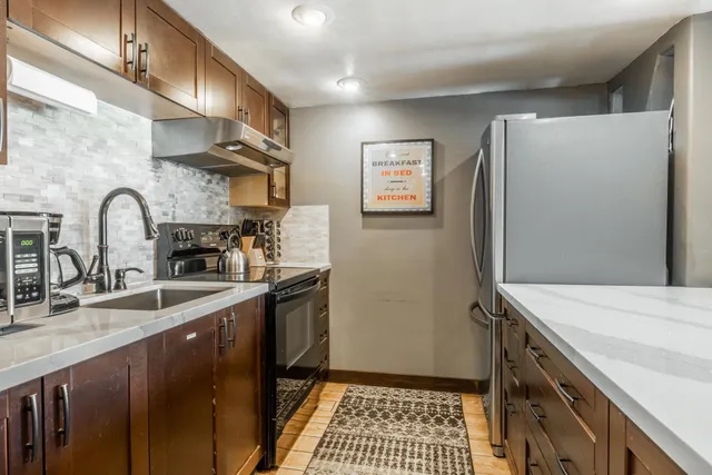 a kitchen with a sink and a refrigerator