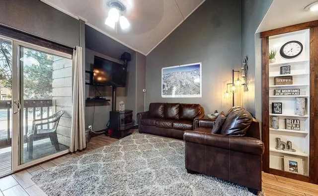 a living room with furniture and a floor to ceiling window