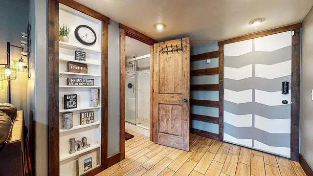 a view of walk in closet with wooden floor